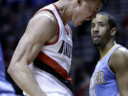 Portland's Meyers Leonard, left, reacts after scoring with Denver Nuggets guard Andre Miller looking on during the second half Wednesday.