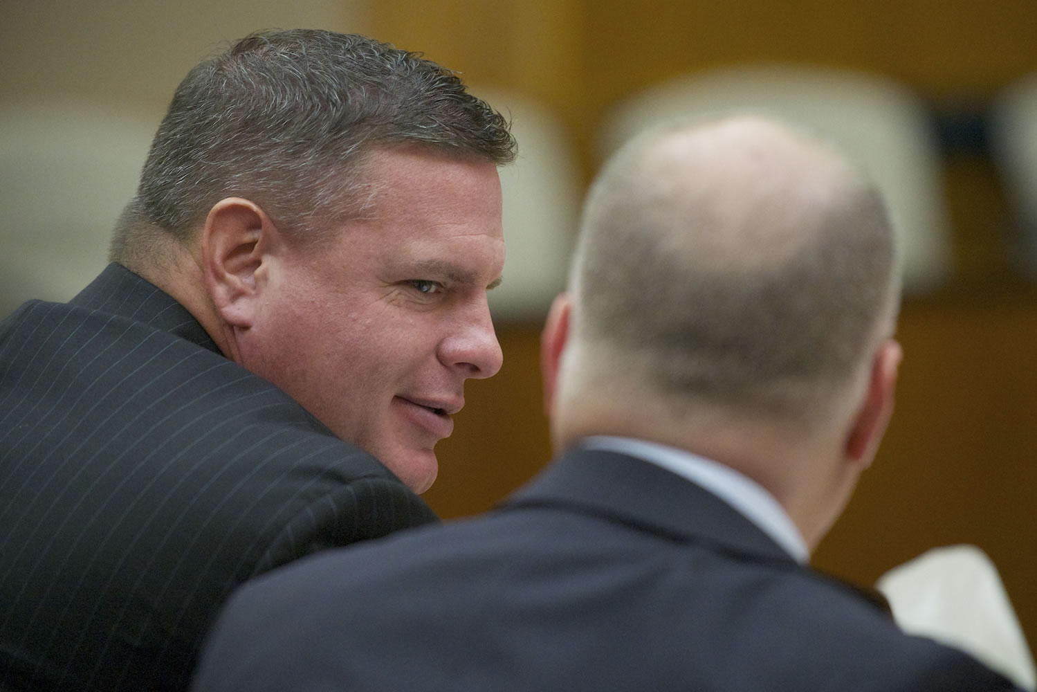 Skamania County's former auditor, John Michael Garvison, left, talks with his attorney, Jon McMullen, at an Oct.