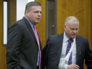 Skamania County's former auditor, John Michael Garvison, left, enters Clark County Superior Court Judge Barbara Johnson's courtroom with his attorney Jon McMullen on Oct.