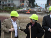 As excavating equipment hums in the background, government and business officials gathered for the ground breaking of the Northwest 38th Avenue/Southeast 20th Street extension project on March 5. Camas Mayor Scott Higgins (left) speaks with Shari Hildreth, deputy district director for U.S. Rep.