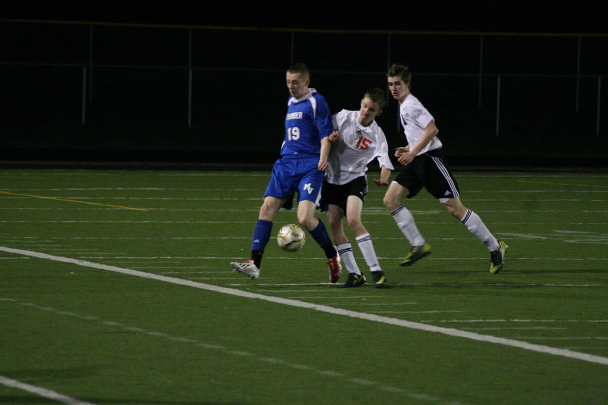 Washougal's Joesph Snedeker and Nicholas Boylan try to take the soccer ball away from Will Warne (19) of Mountain View Monday, at Fishback Stadium.