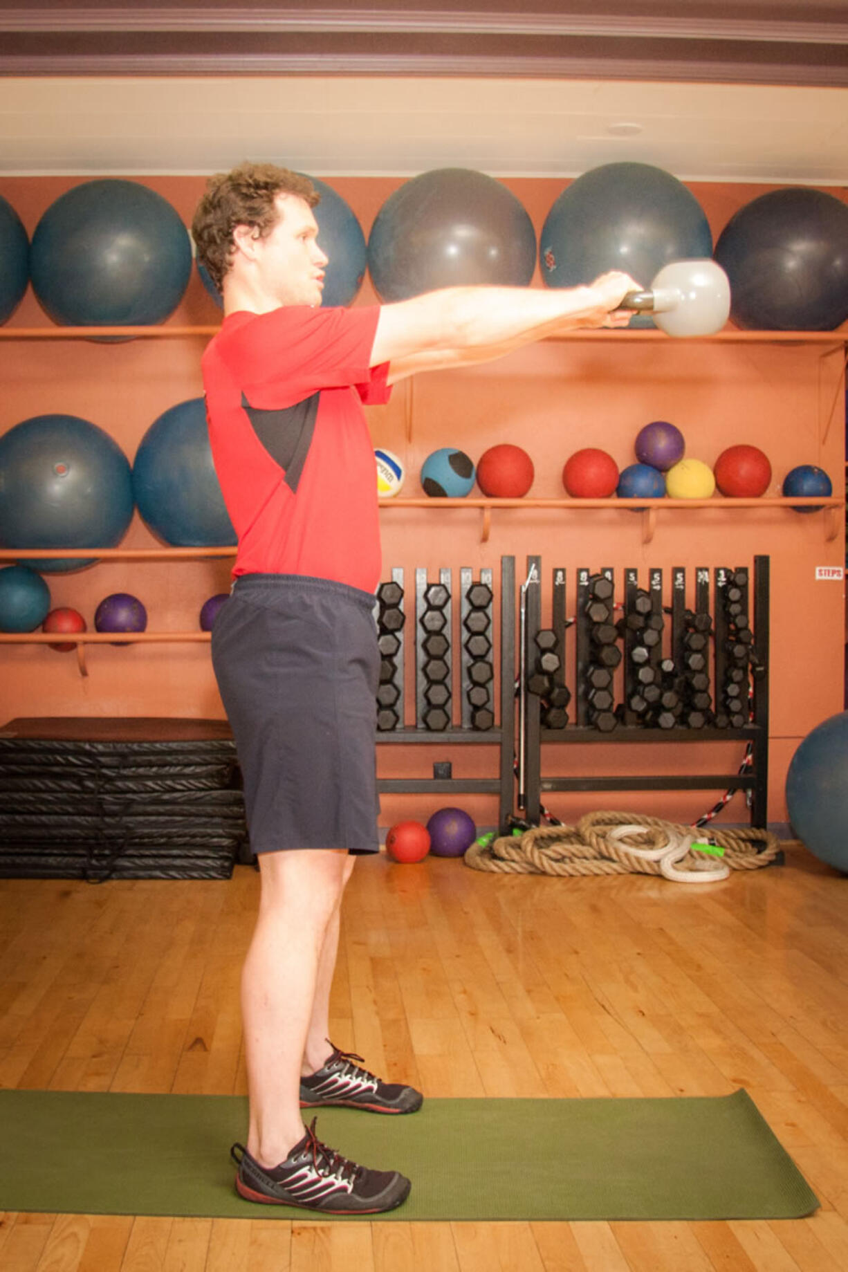 Personal trainer Derrick DeLay performs kettlebell swings.