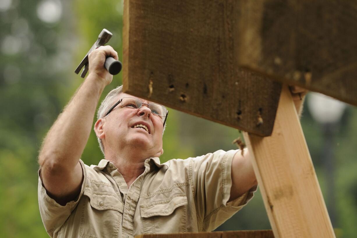 Washougal: Richard Johnson, pictured here in 2011 as he helps construct a historically accurate replica of a waterwheel in Vancouver, was recently picked as the new president of the Camas-Washougal Historical Society.