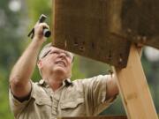 Washougal: Richard Johnson, pictured here in 2011 as he helps construct a historically accurate replica of a waterwheel in Vancouver, was recently picked as the new president of the Camas-Washougal Historical Society.