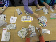 Members of the Savvy Savers Coupon Clippers gather twice a month to swap their unwanted coupons for ones they want/need at Southeast Regional Library in Garner, N.C.