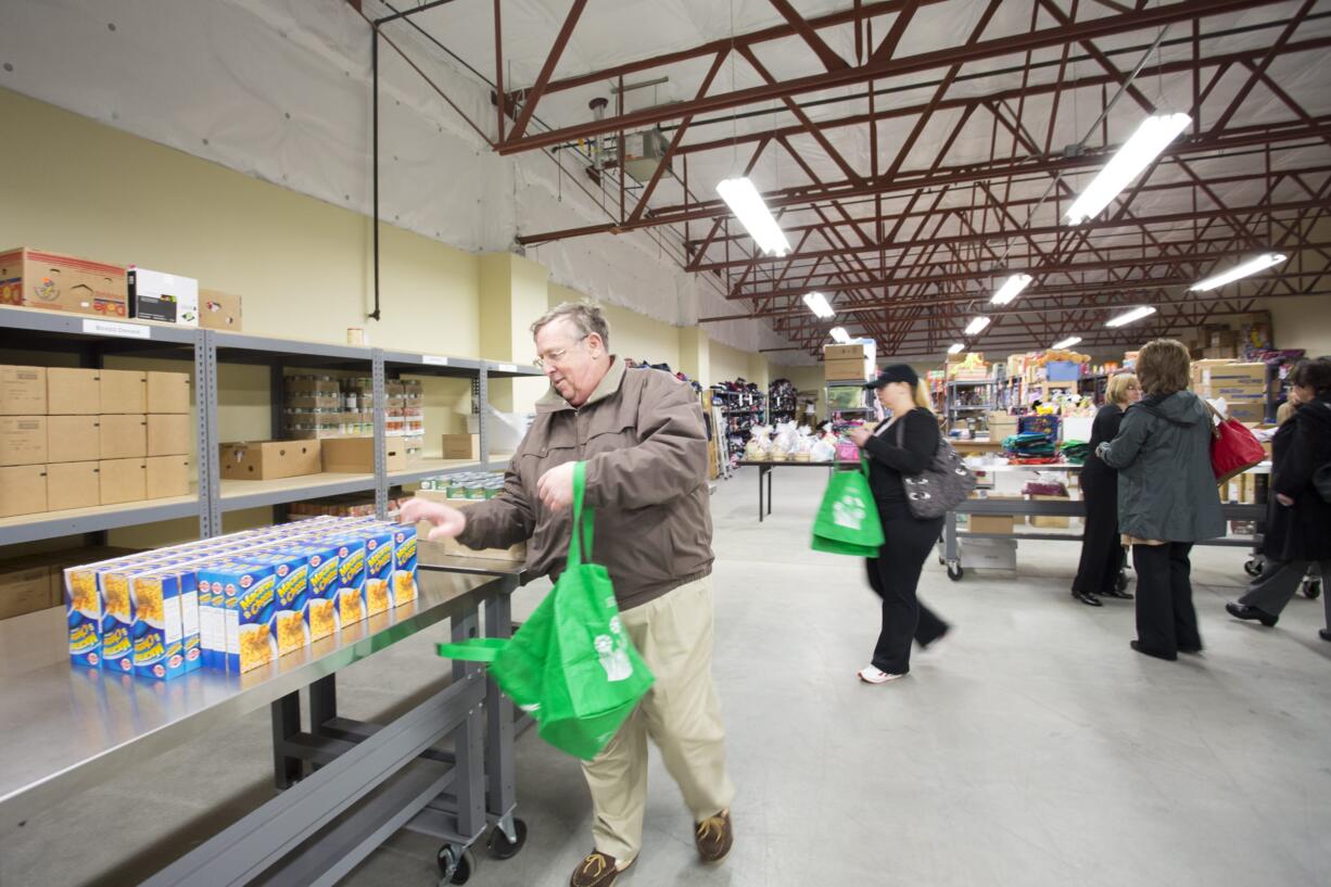 Columbian files
Mark Wardlaw, a Share volunteer, fills bags with food on March 19 at the Share Fromhold Service Center.