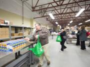 Columbian files
Mark Wardlaw, a Share volunteer, fills bags with food on March 19 at the Share Fromhold Service Center.