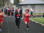 Kaitlyn Johnson (left) captured first place for Washougal in the 100, 200 and the triple jump Thursday, in Longview.