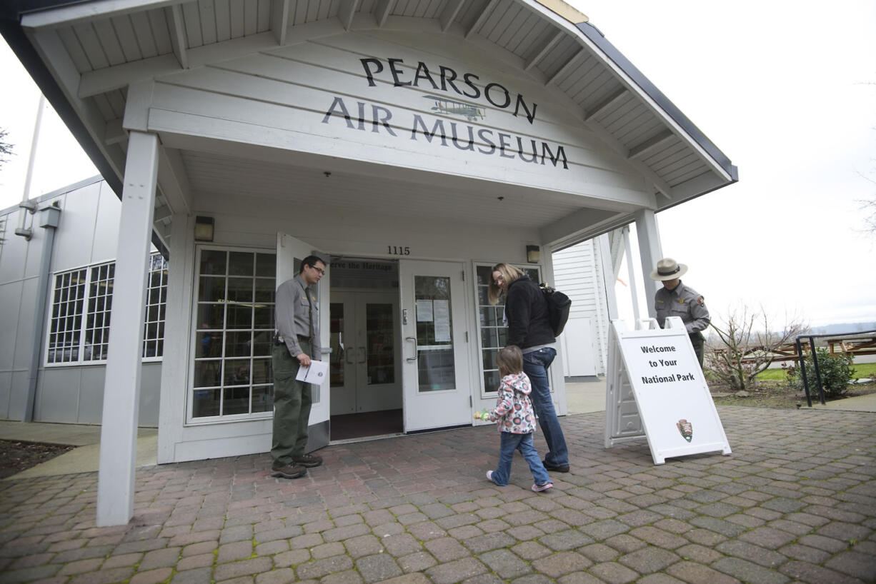 Aaron Ochoa, a National Park Service ranger, left, opens a door at the reopening of the Pearson Air Museum on Feb. 2, 2013.