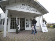 Aaron Ochoa, a National Park Service ranger, left, opens a door at the reopening of the Pearson Air Museum on Feb. 2, 2013.