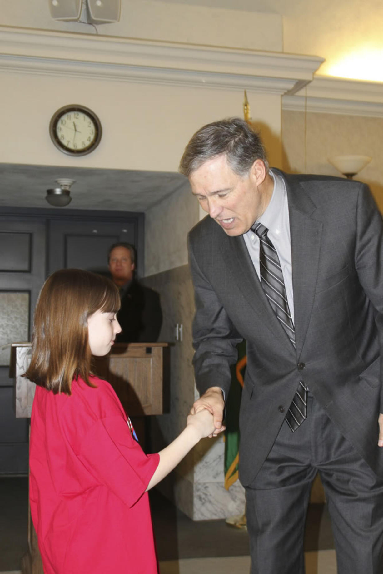 Paige Maas, a Hathaway Elementary School third-grader, shakes hands with Gov.