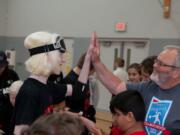 A student celebrates with a volunteer after participating in a Northwest Association of Blind Athletes goalball tournament in March, in Canby, Ore. &quot;It is a game that requires superb hearing skills, excellent reflexes and superb mental concentration,&quot; said Billy Henry, co-founder of the NWABA.