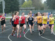 Camas runners Alexa Efraimson and Alissa Pudlitzke (left to right) stuck by each other in the 3,200-meter run during the John Ingram Twilight track and field meet Friday, at Columbia River High School. Pudlitzke won this race by setting a 16-second personal best time.