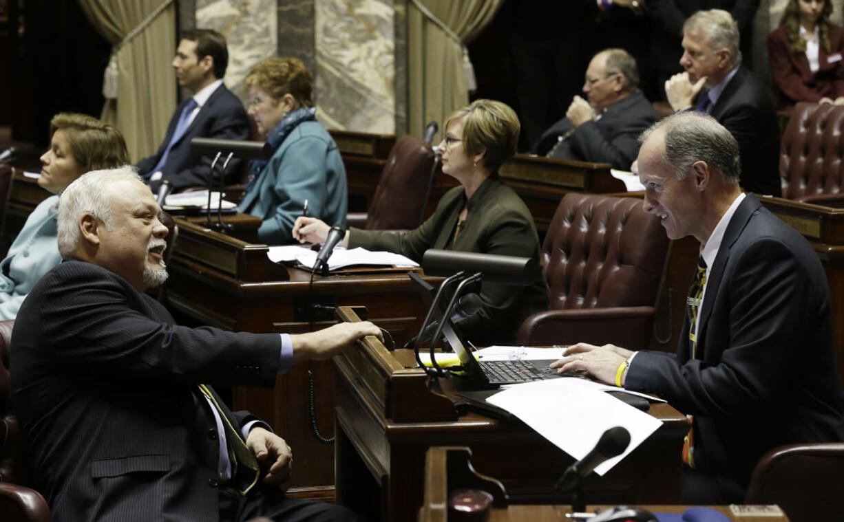 Senate Majority Leader Rodney Tom, D-Medina, right, chats with Sen. Don Benton, R-Vancouver, left, on the Senate floor in January. The session comes to a close this weekend.