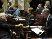 Senate Majority Leader Rodney Tom, D-Medina, right, chats with Sen. Don Benton, R-Vancouver, left, on the Senate floor in January. The session comes to a close this weekend.