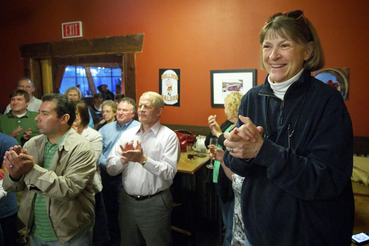 Shonny Bria, right, former superintendent of Battle Ground Public Schools, reacts to the news that the district passed its four-year maintenance and operations levy on April 23. District residents have sharply criticized the school board for its secrecy surrounding the buyout of the contract for Bria, who retired June 30.