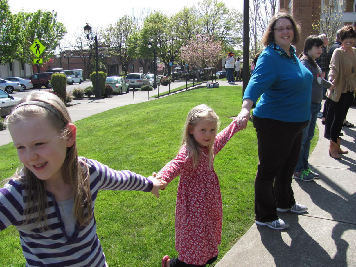 Patrons of all ages gathered April 17, to &quot;hug&quot; the Camas Public Library, in celebration of its 90th birthday.