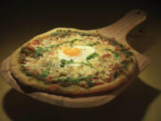 A breakfast-style pizza with a fried egg on top brings out the kid in us.