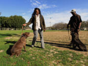 Larry Hill, right, and his dog, Ryder, train Pamela Henderson and her dog, Gabriel, in South Los Angeles.