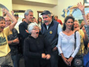 Measure 15-119 supporters react after learning that Roughly 66 percent of Jackson County voters favored banning GMO crops in the first round of election results released tonight while gathered at Capers Restaurant in Medford Ore. on May 20, 2014.