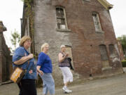 Kathleen Saxton, right, walks around the outside of the Academy with a few of her friends in July 2009 during the Clark County Historical Museum walking tour of Mother Joseph's Providence Academy.