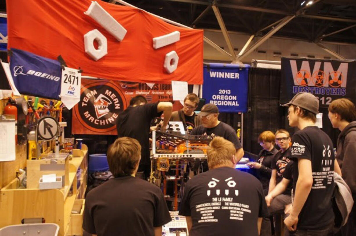 Students on the Camas-Washougal Robotics Team, known as &quot;Team Mean Machine,&quot; make adjustments to their robot, Odd Job, during a competition.