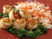 Peanut-crusted scallops with coconut-carrot rice topped on bed of spinach make for a quick meal.