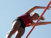 Caleigh Lofstead lets go of her pole vault after she clears the bar.