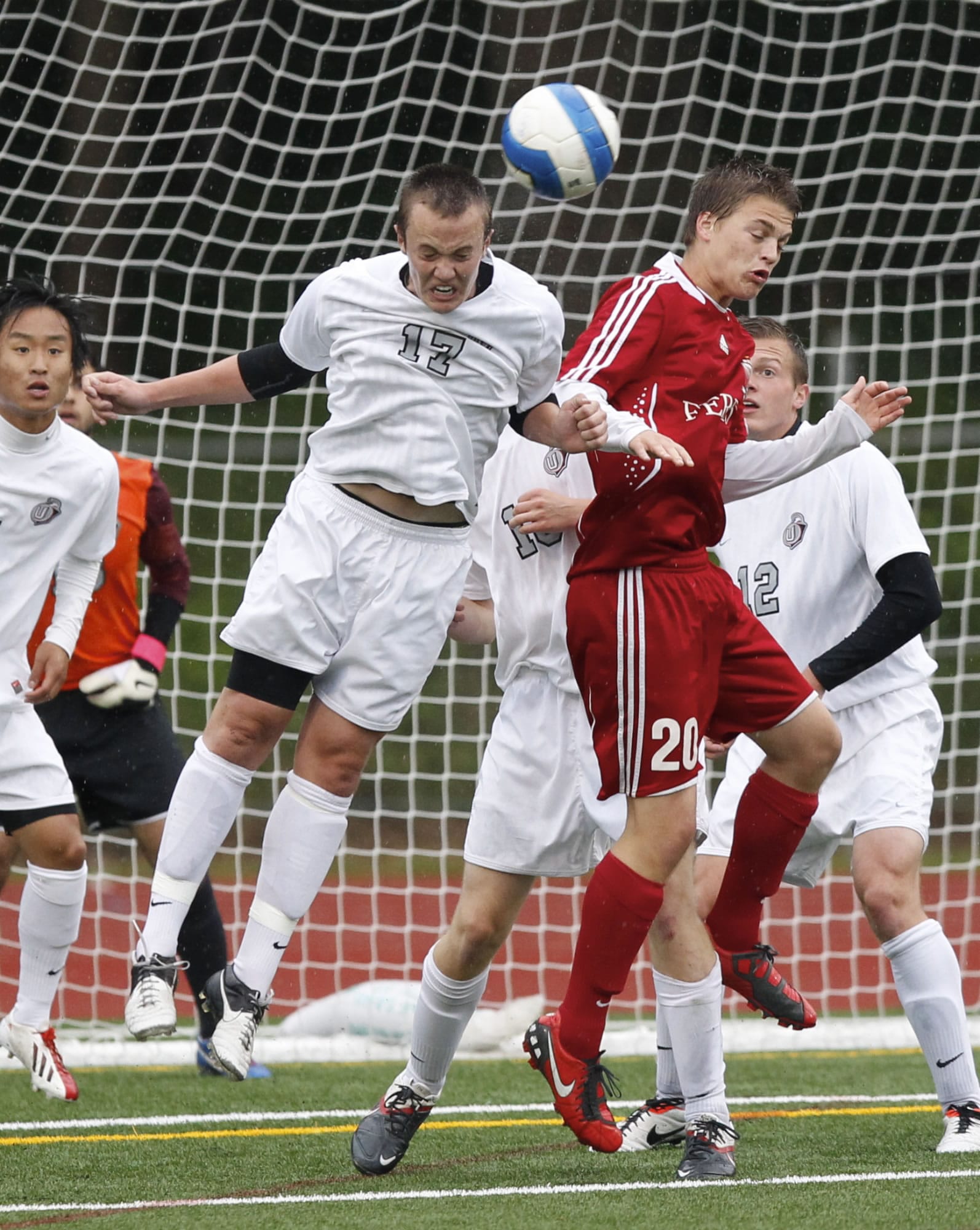 Union forward Mitch Wheelon (17) heads ball against Ferris midfielder Matt Belles (20) during state soccer quarterfinal game Saturday.