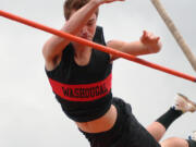 Adam Thomas soars over the bar set at 13 feet for the first time this season to earn second place in the pole vault during the 2A district track and field meet Friday, at Fishback Stadium.