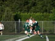 Camas forward Nate Beasley bursts through two Skyline Spartans May 14, at Doc Harris Stadium.