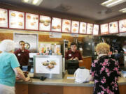 Photos by George Skene/Orlando Sentinel
This Chick-fil-A in Orlando, Fla., has menus with caloric values. McDonald's and Panera have done the same. Grocers are fighting a federal requirement to post calories for food made at stores, such as sandwiches.