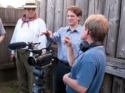 Brett Oppegaard, center, sets up a scene during production of a &quot;Kanaka Village&quot; video segment for the mobile storytelling app at Fort Vancouver National Historic Site.