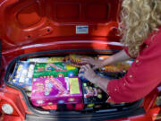 Nikii Davis of Portland packs a year's supply of fireworks into the trunk of her car at Blackjack Fireworks in Vancouver on the first day of sales in Washington in June 2008. She spent $130.