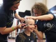 Washougal third-grader and cancer survivor Sammy Mederos reacts to getting her long locks of curly hair shaved off during a fundraiser for St. Baldrick's Foundation this afternoon at Washougal High School. Mederos was diagnosed with leukemia when she was in kindergarten. Mederos and her family helped organize the event, which included participation by Washougal Mayor Sean Guard and Cape Horn-Skye Elementary School secretary Mary La France--a breast cancer survivor.