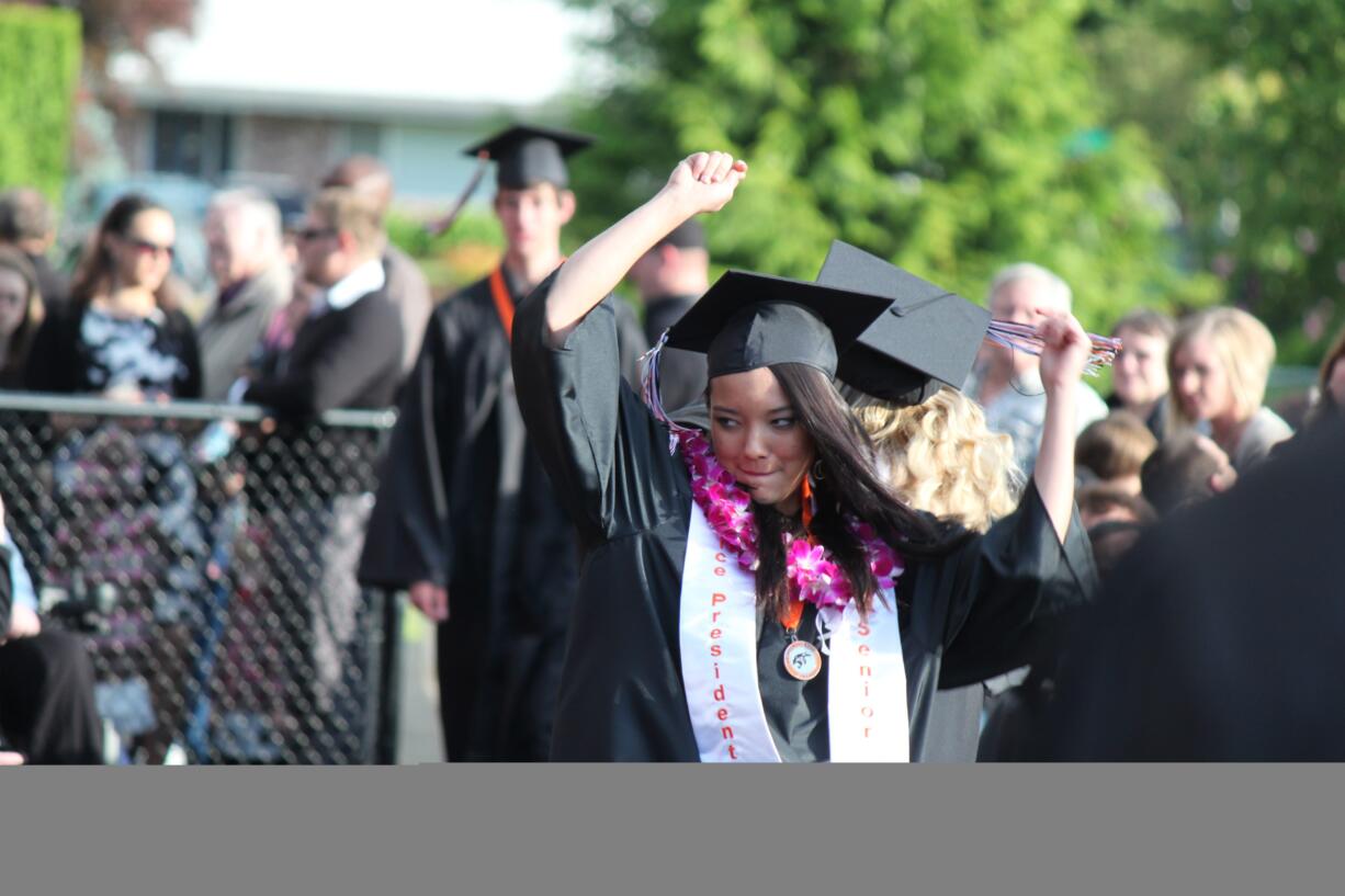 Senior class vice president Kim Yano gets into the spirit of the occasion as she makes her way into Fishback Stadium Saturday night.