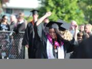 Senior class vice president Kim Yano gets into the spirit of the occasion as she makes her way into Fishback Stadium Saturday night.