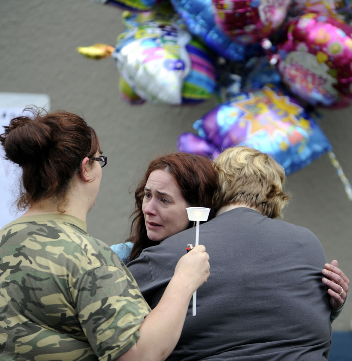 Jennifer Kanna, Benjamin Fulwiler's mother, is consoled by friends at a vigil to celebrate what would have been his 12th birthday.