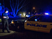 Vancouver Police Officer Brian Ruder secures a perimeter around the scene of a double homicide in the McLoughlin Heights neighborhood in February 2009.