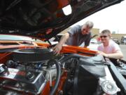 Car lovers, including Roy Rhine and son Trevor with his '68 Pontiac Firebird, gather Sunday at Pied Piper Pizza in Orchards for the annual Father's Day Cruise-in to benefit the Relay for Life cancer effort.