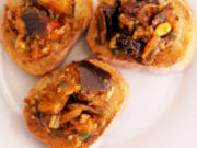 Eggplant caponata on toasted baguette slices.