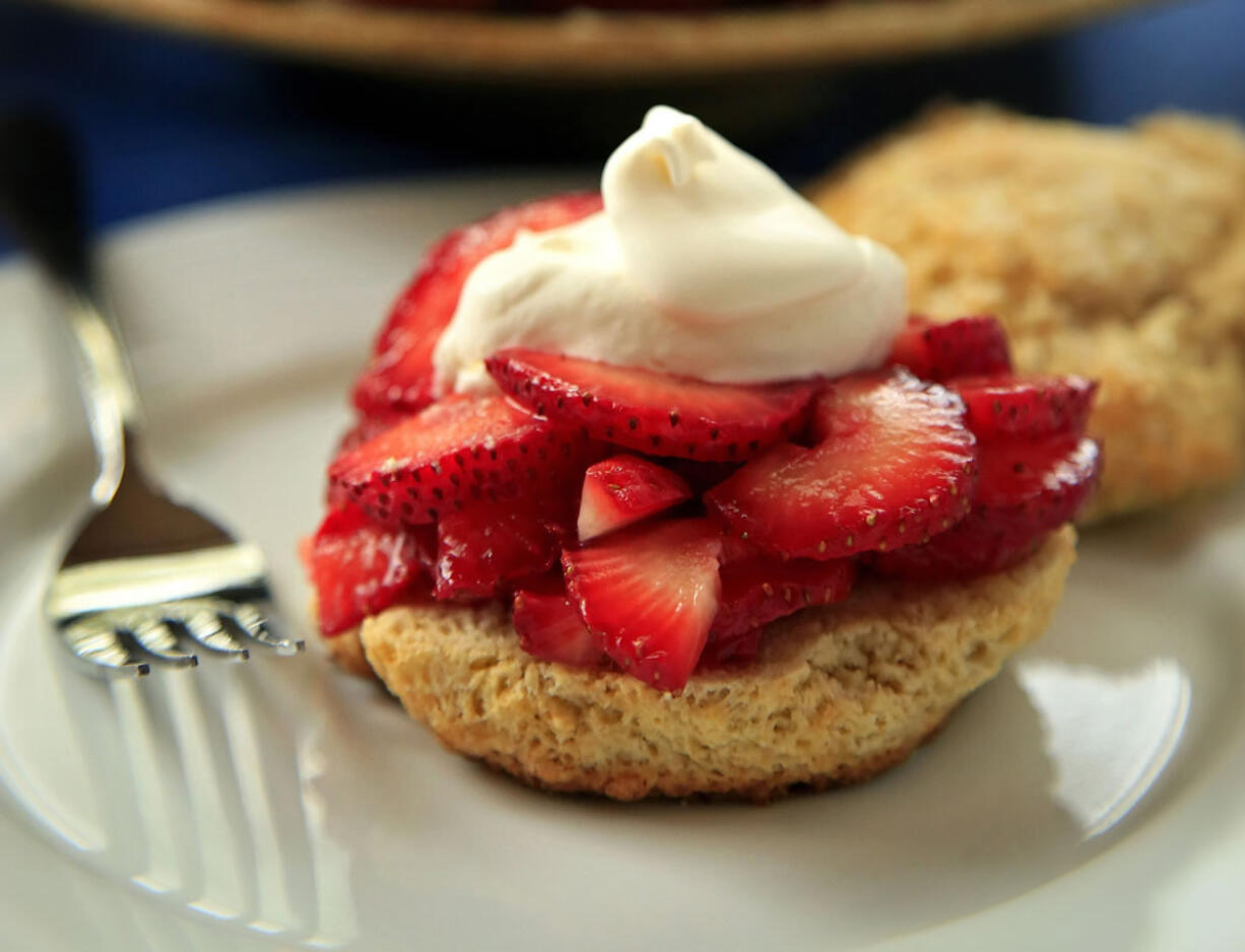 Strawberry shortcake topped with a dollop of whipped cream is a delectable creation.