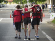 Exhausted after finishing third in the Vancouver USA Marathon in 2:49:29, San Francisco's David Kyle, 34, is aided by medical attendants.