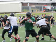 Camas quarterback Reilly Hennessey receives plenty of protection from his linemen during a scriammage game with Washougal June 12, at Cardon Field.