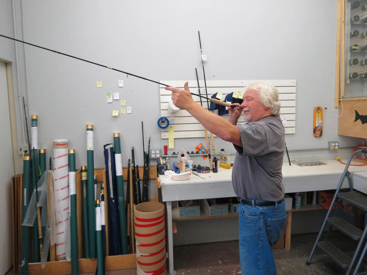 Carl Francis &quot;Kerry&quot; Burkheimer III smiles at the finished product of a fly rod built in his downtown Washougal shop.