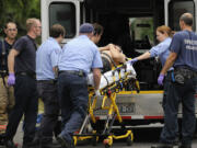 Vancouver paramedics rush a shooting victim into an ambulance on East McLoughlin Boulevard in September 2010.