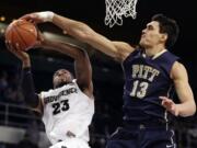 Pittsburgh center Steven Adams (13), blocking a shot by Providence forward LaDontae Henton (23), is a possible first round pick in the NBA Draft on Thursday.