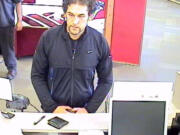 Surveillance tapes allegedly show suspect Brent Woodall  holding up the Bank of America on Auto Mall Drive.