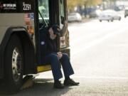 Bus driver Al Purvis sits at the scene of a Dec.