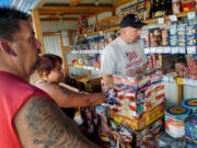 Bill and Twila Williams of La Center make their fireworks selections in 2007 as Lonnie McCann of Discount Fireworks assists at the stand located near the Clark County Fairgrounds. Clark County residents have the opportunity this election to vote on up to six nonbinding questions proposed by Clark County commissioners.